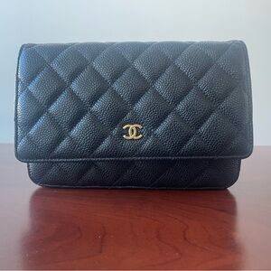CHANEL Quilted Black Clutch with Gold Emblem